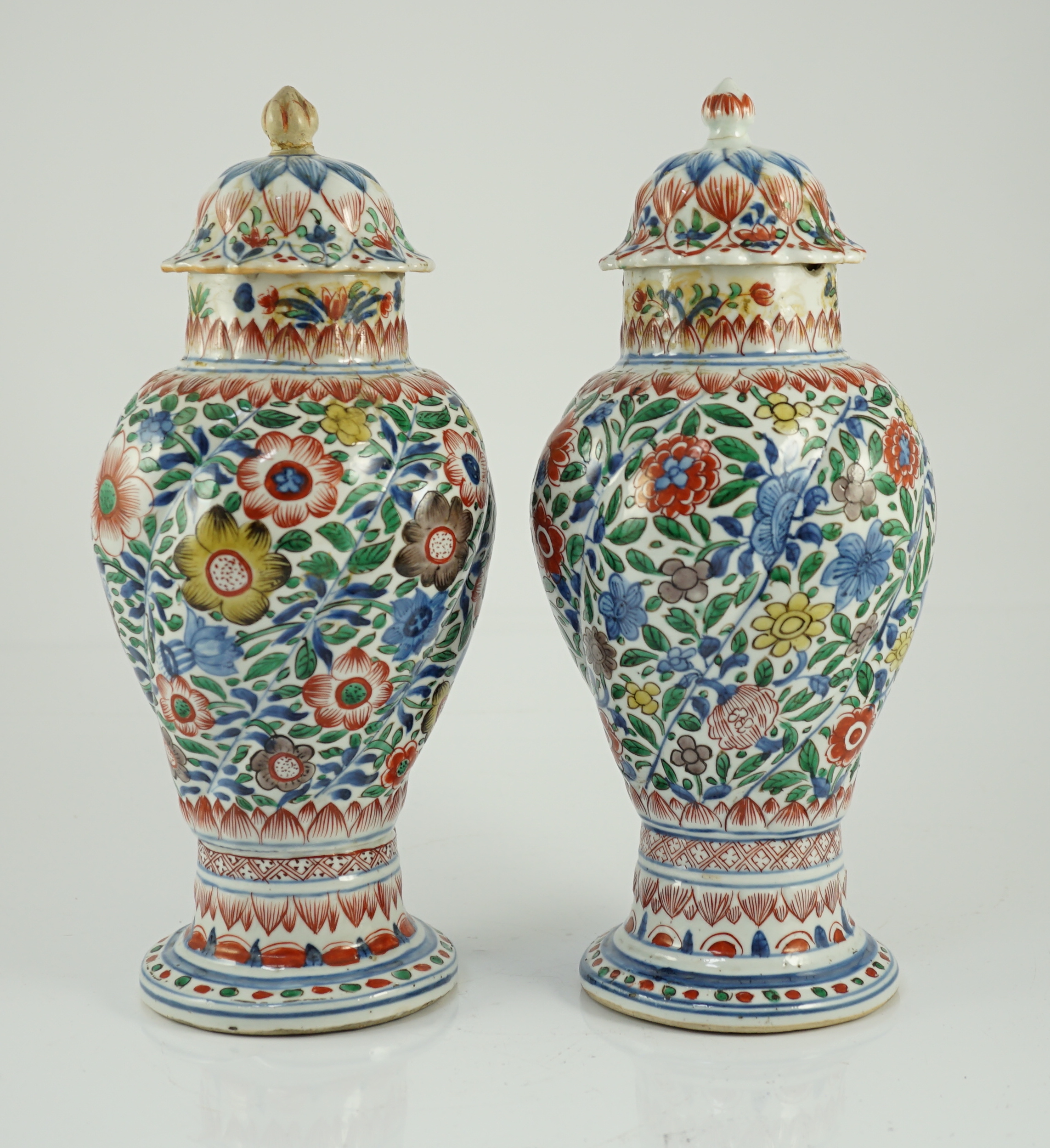 A pair of Chinese wucai spiral lobed baluster vases and covers, Kangxi, c.1680